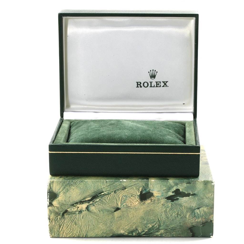 The image shows an open green Rolex watch box for the Vintage Collection model, resting on a textured outer box.