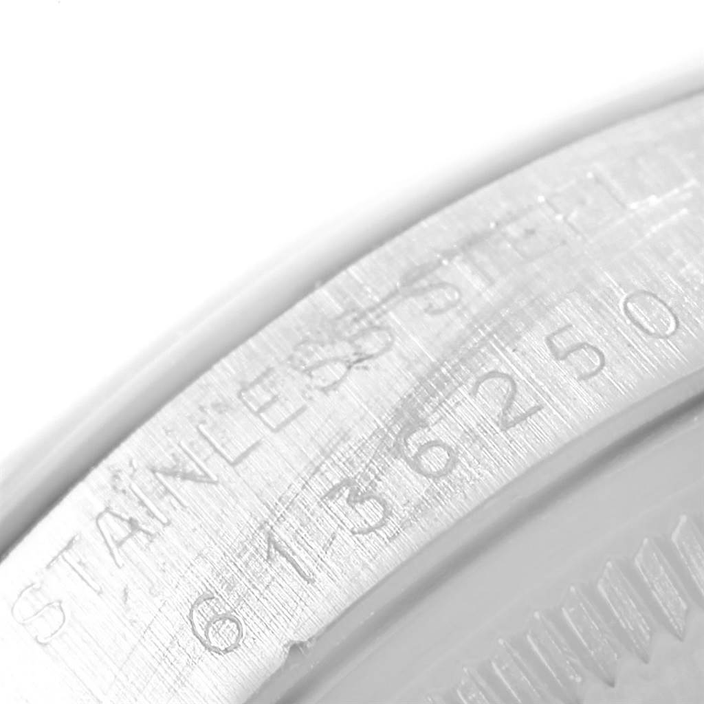 This close-up image of the Rolex Vintage Collection 1500 Men's Stainless Steel Silver Dial 1500 Men's Stainless Steel Silver Dial watch shows the engraved serial number and "STAINLESS STEEL" on the case back edge.