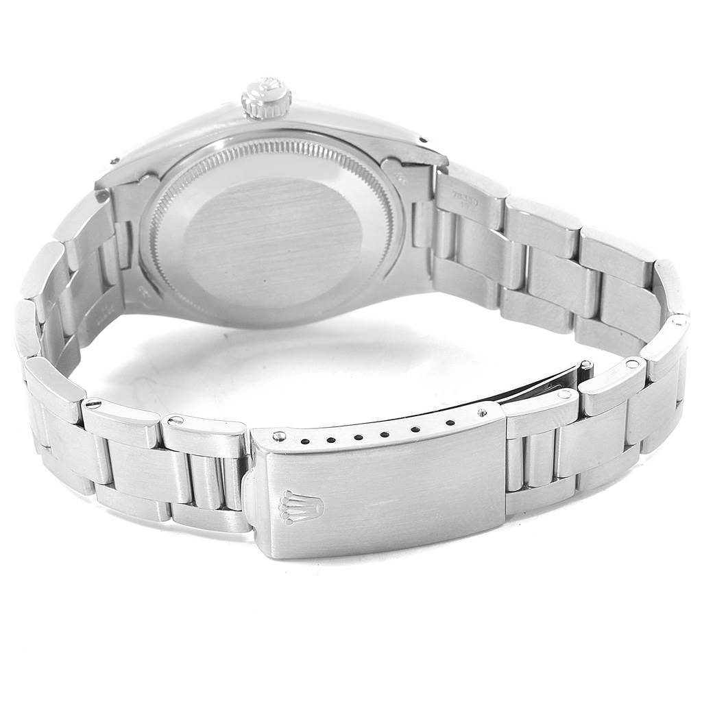 The image shows the back view of a Rolex Vintage Collection 1500 Men's Stainless Steel Silver Dial 1500 Men's Stainless Steel Silver Dial watch, highlighting its case back, crown, and metal bracelet.