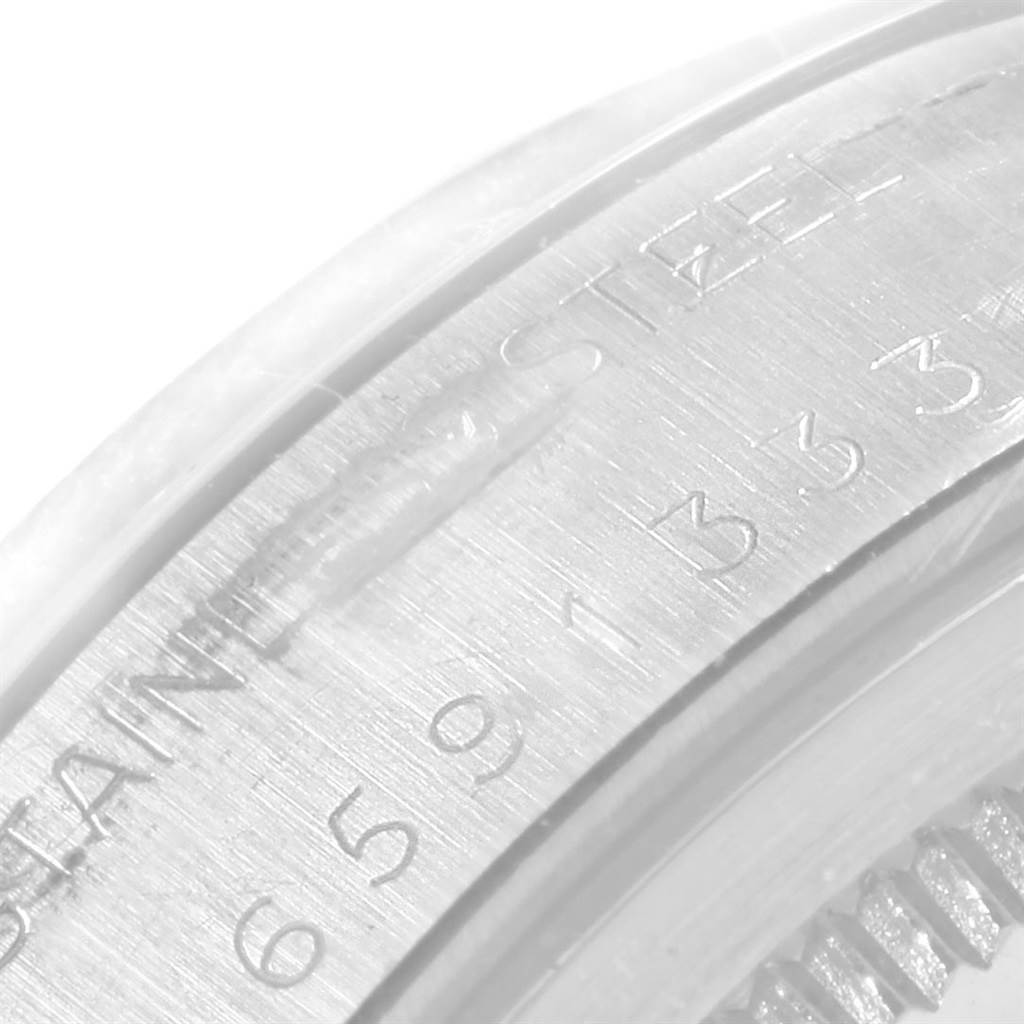The image shows a close-up of the side of the bezel with engraved text and numbers on a Rolex Vintage Collection 6694 Men's Stainless Steel White Dial 6694 Men's Stainless Steel White Dial model.