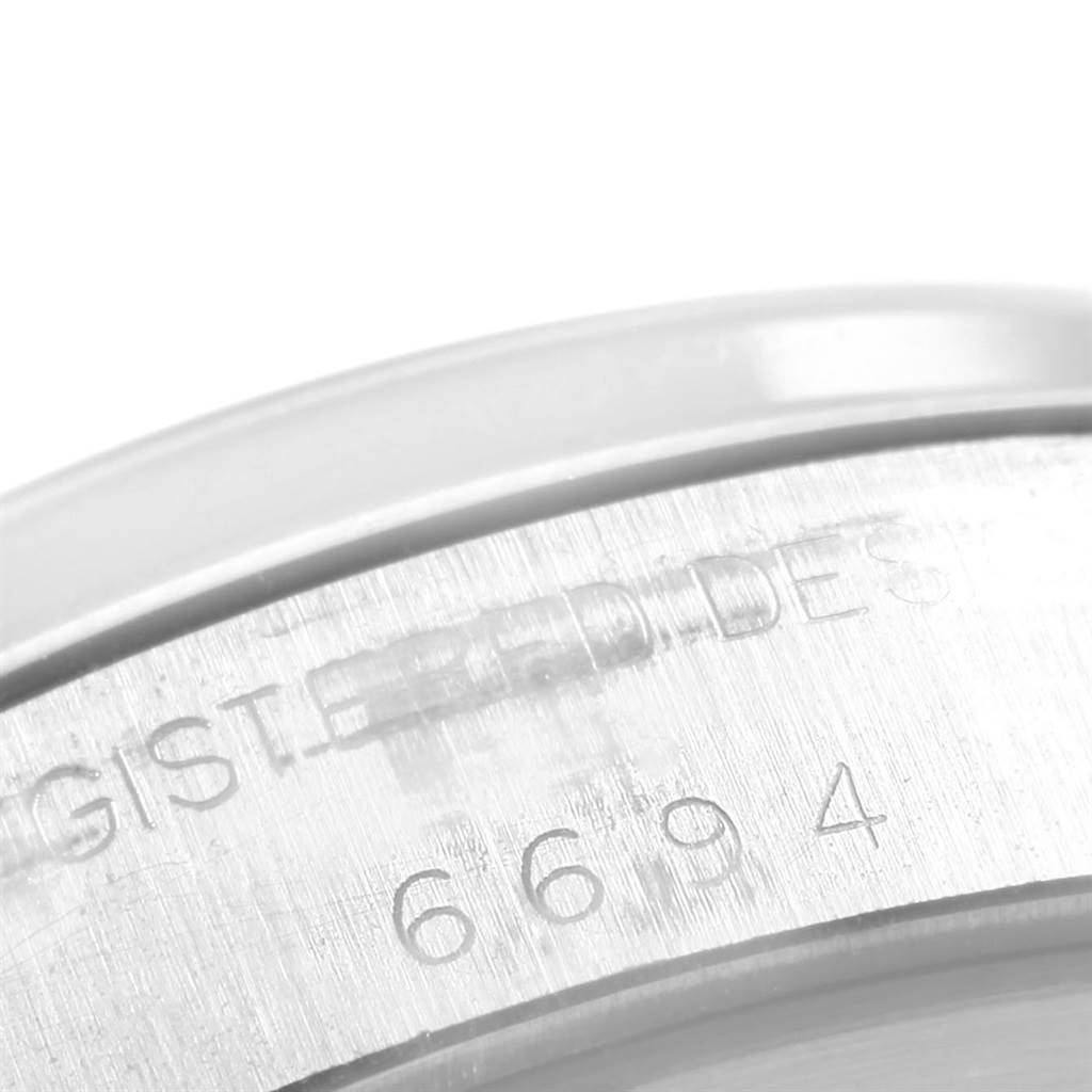 This image shows a close-up of the Watch casing engraving for the Rolex Vintage Collection 6694 Men's Stainless Steel White Dial 6694 Men's Stainless Steel White Dial model.