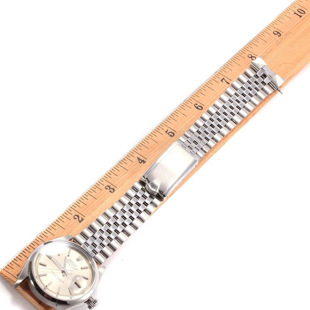 The Rolex Vintage Collection 1600 Men's Stainless Steel Silver Dial 1600 Men's Stainless Steel Silver Dial model watch is shown in a top-down view, including the face, bracelet, and clasp, aligned with a ruler.