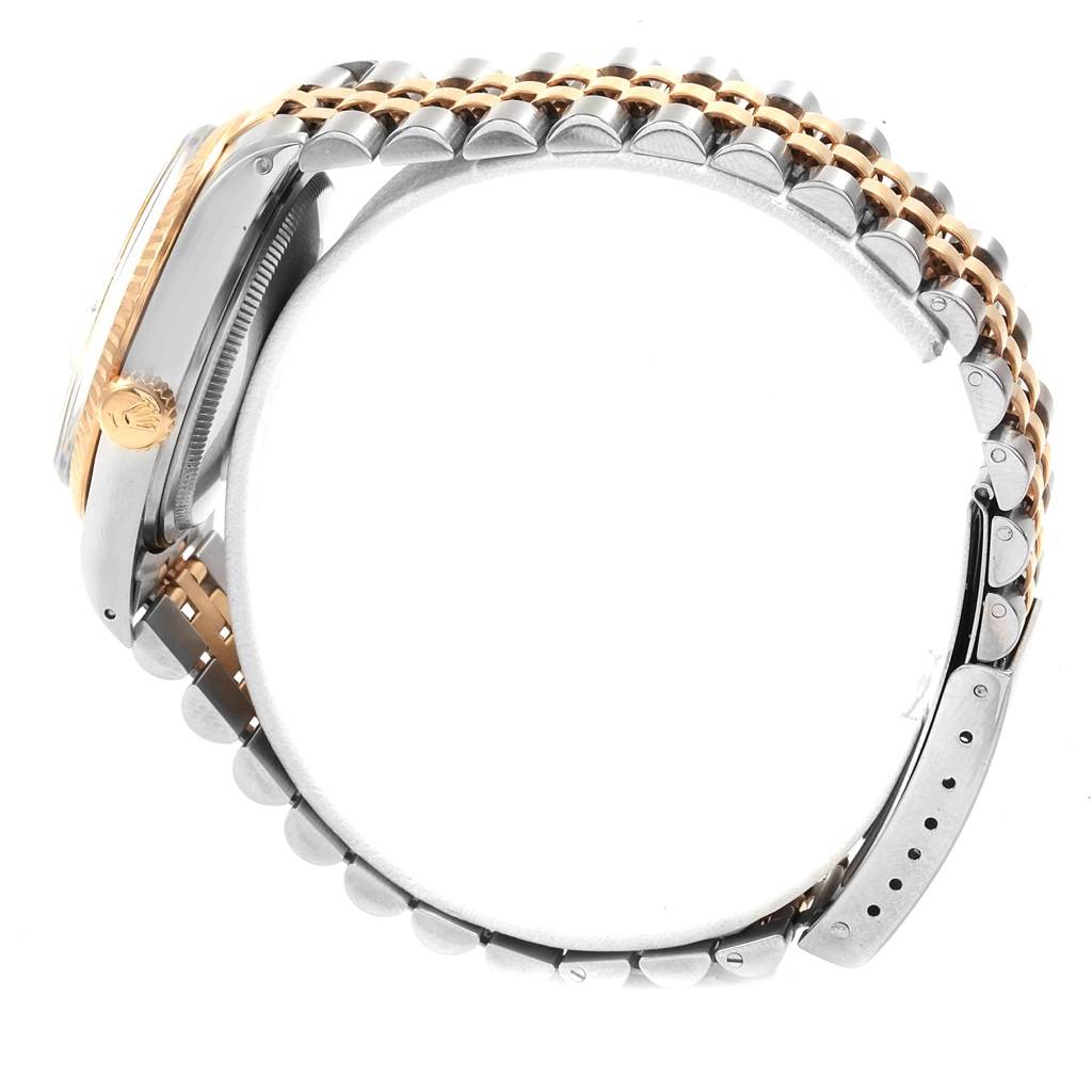 The image shows the side view of a Rolex Vintage Collection 16013 Men's Stainless Steel Silver Dial 16013 Men's Stainless Steel Silver Dial watch, highlighting its case, crown, and two-tone bracelet.