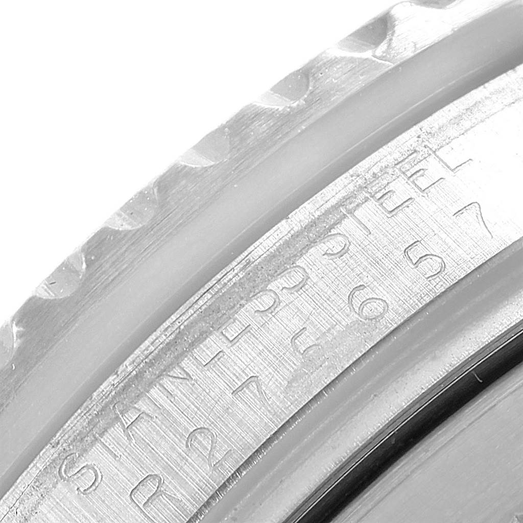 This close-up image shows the engraved numbers and text on the stainless steel rim of a Vintage Collection model by Rolex.