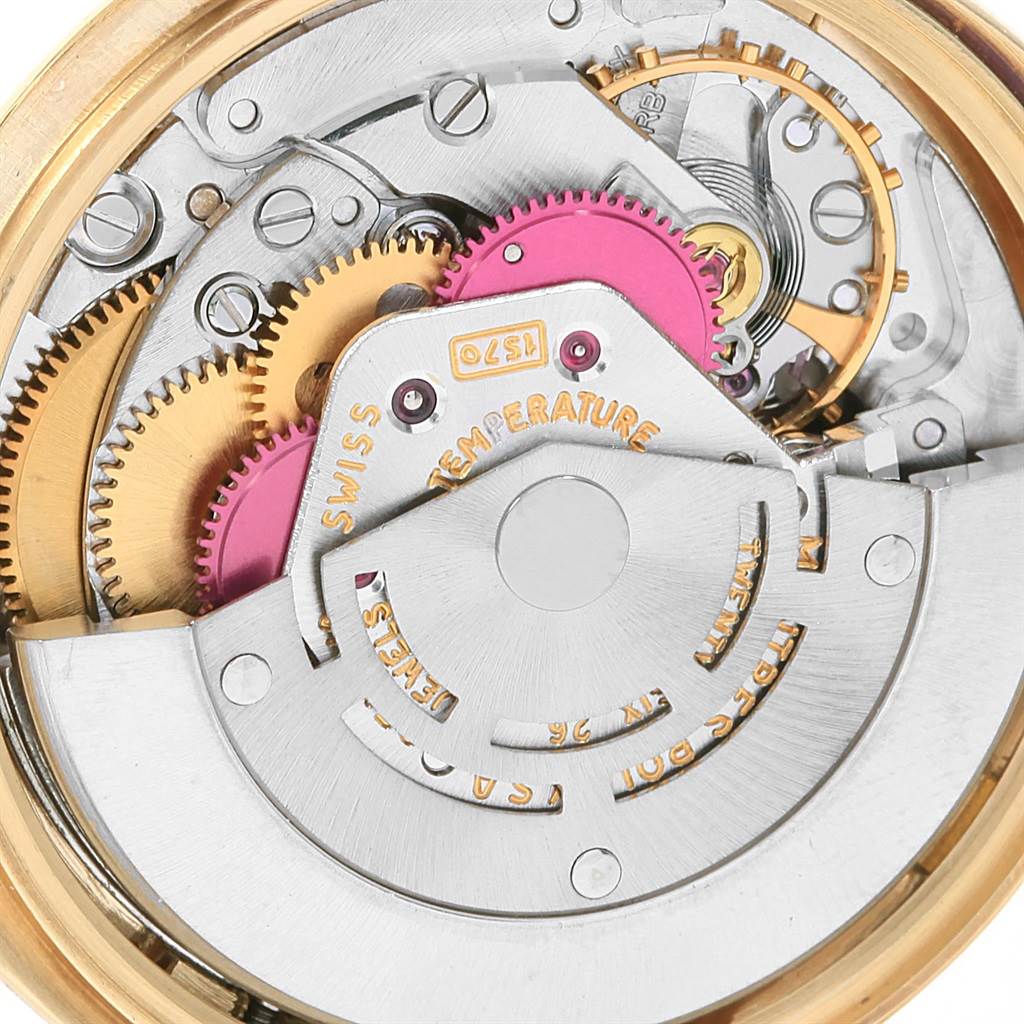 This image shows a close-up view of the internal mechanics and gears of a Vintage Collection Rolex watch.