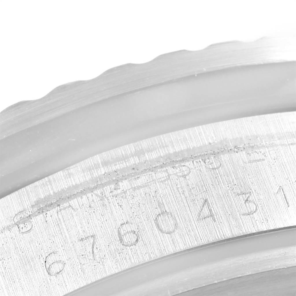 The image features a close-up view of the engraved serial number on the side of the Rolex Vintage Collection 1665 Men's Stainless Steel Black Dial 1665 Men's Stainless Steel Black Dial watch case.