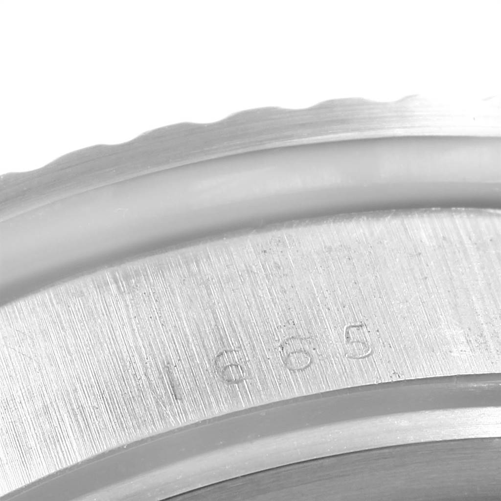 This image shows a close-up angle of the bezel and part of the casing of the Rolex Vintage Collection 1665 Men's Stainless Steel Black Dial 1665 Men's Stainless Steel Black Dial model.