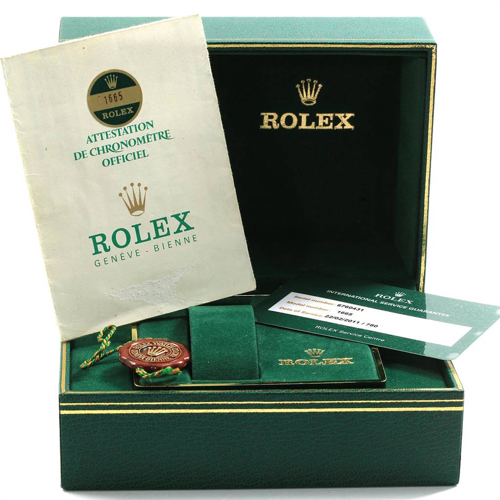 The image shows a Rolex Vintage Collection 1665 Men's Stainless Steel Black Dial 1665 Men's Stainless Steel Black Dial box with a certificate, service card, and tag inside.