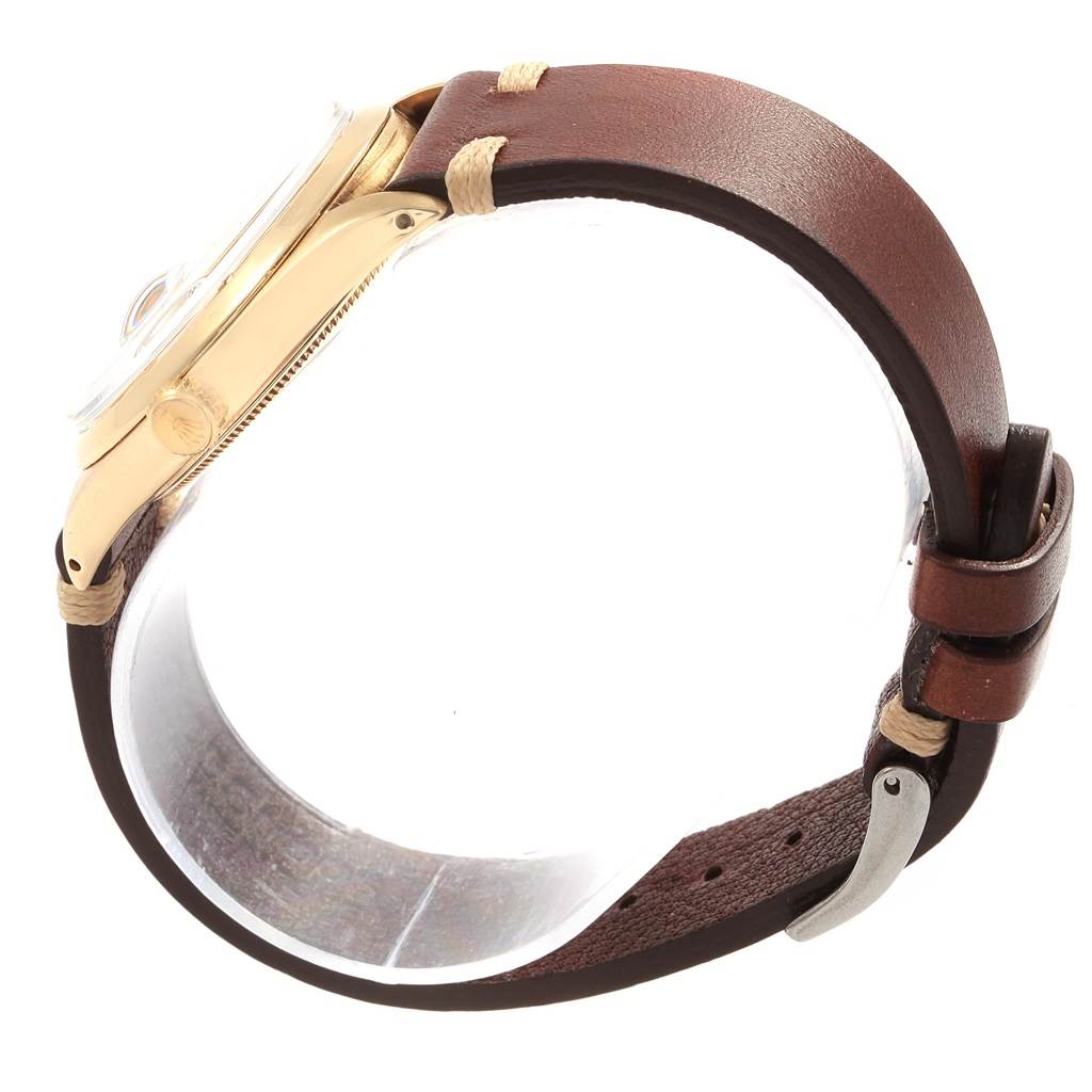 The Rolex Vintage Collection 1500 Men's Yellow Gold Silver Dial 1500 Men's Yellow Gold Silver Dial watch is shown from the side, highlighting its brown leather strap and gold case.