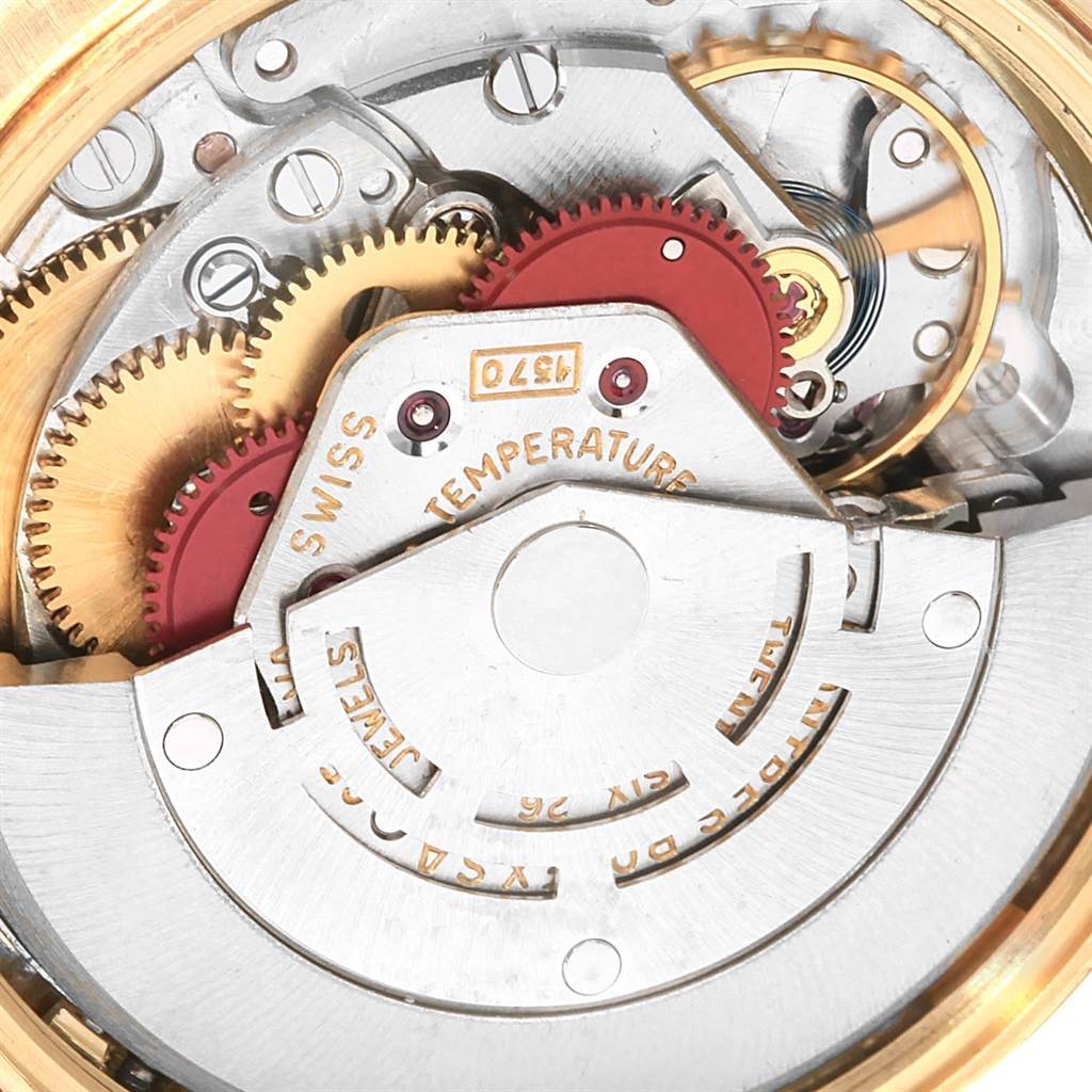 This image shows the intricate internal mechanism of a Rolex Vintage Collection 1500 Men's Yellow Gold Silver Dial 1500 Men's Yellow Gold Silver Dial watch, highlighting gears and temperature markings.