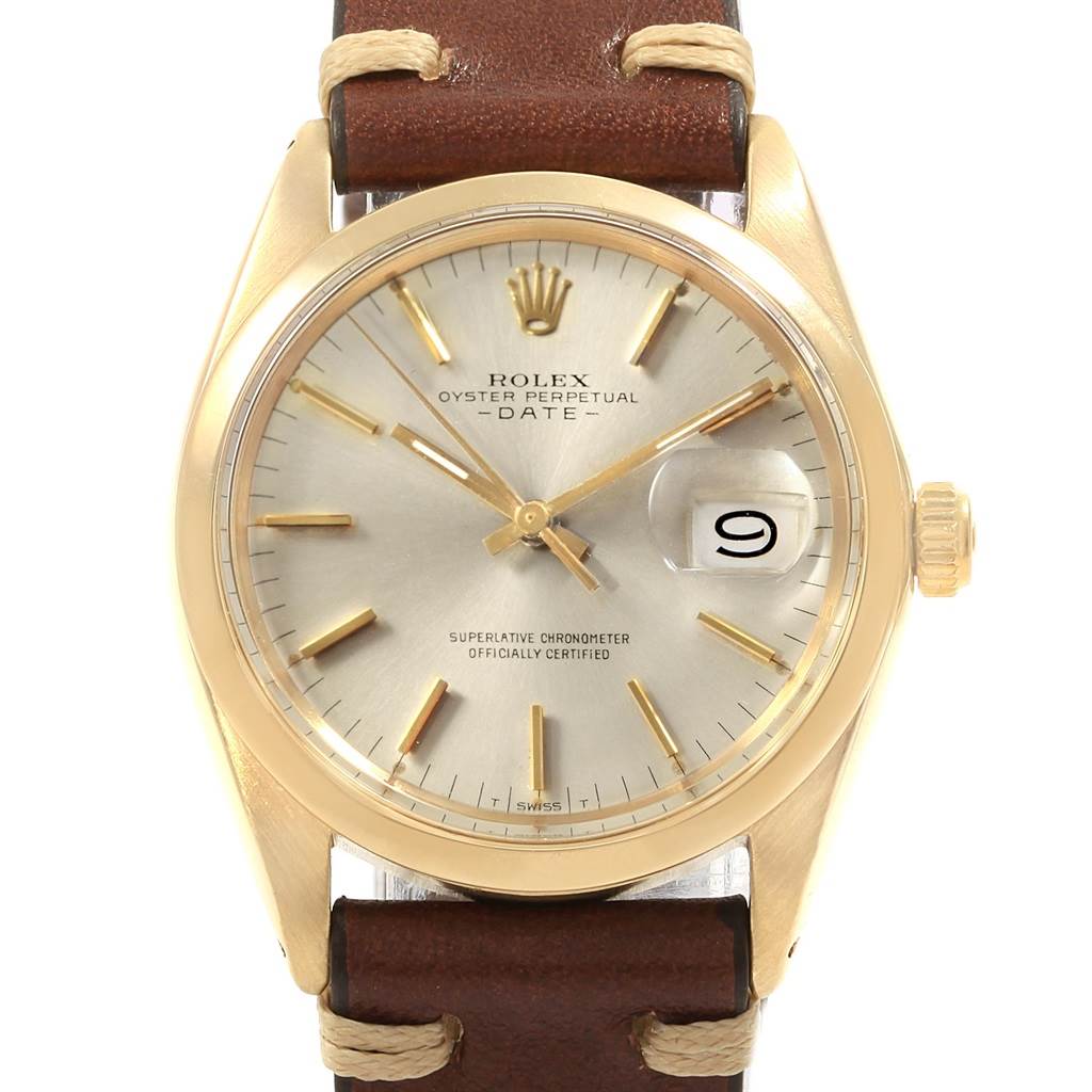 The image shows a close-up of the Rolex Vintage Collection 1500 Men's Yellow Gold Silver Dial 1500 Men's Yellow Gold Silver Dial model, capturing the full face, date window, crown, and a portion of the leather strap.