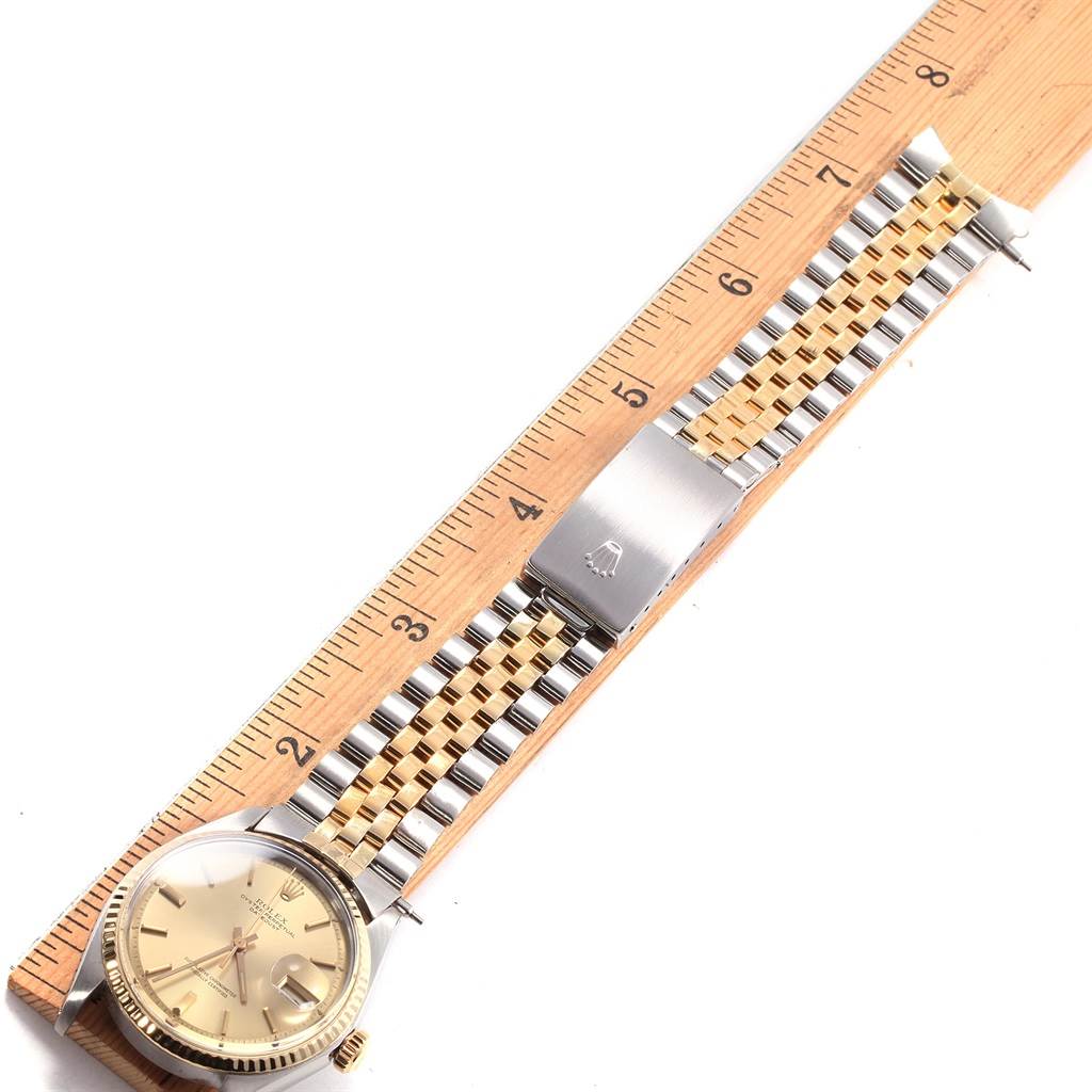 The image shows a Rolex Vintage Collection 1601 Men's Steel and Gold (two tone) Silver Dial 1601 Men's Steel and Gold (two tone) Silver Dial watch viewed from above, focusing on the watch face, band, and clasp, beside a ruler.