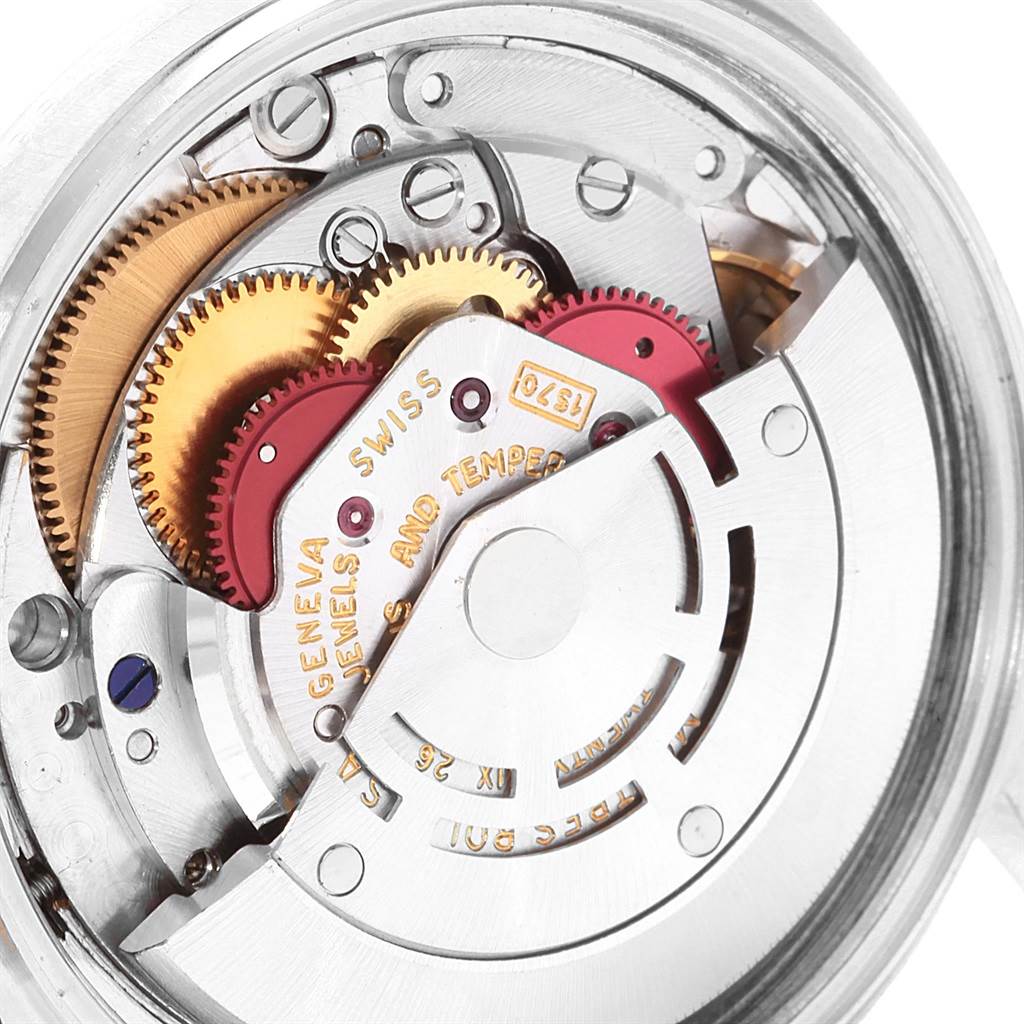 The image shows an up-close view of the intricate internal mechanisms of a Rolex Vintage Collection 1601 Men's Steel and Gold (two tone) Silver Dial 1601 Men's Steel and Gold (two tone) Silver Dial watch.