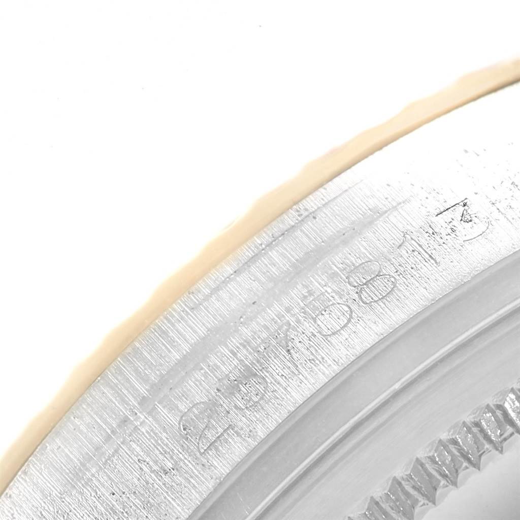 This close-up angle of the Rolex Vintage Collection 1601 Men's Steel and Gold (two tone) Silver Dial 1601 Men's Steel and Gold (two tone) Silver Dial watch shows part of the casing and engraved serial number.