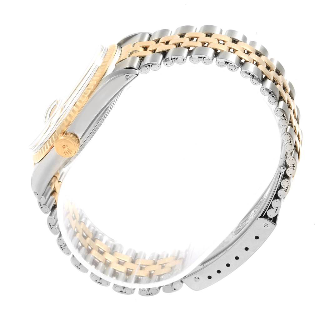 The Vintage Collection Rolex watch is shown at a side angle, highlighting its two-tone bracelet and crown.