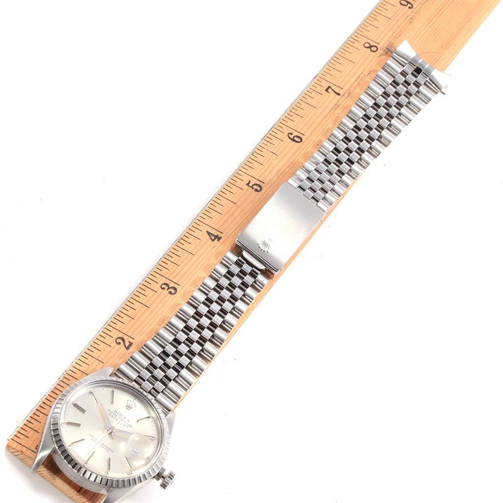 The image shows a Rolex Vintage Collection 16030 Men
s Stainless Steel Silver Dial 16030 Men
s Stainless Steel Silver Dial watch laid flat, showcasing the face, bezel, and full metal strap, next to a ruler.