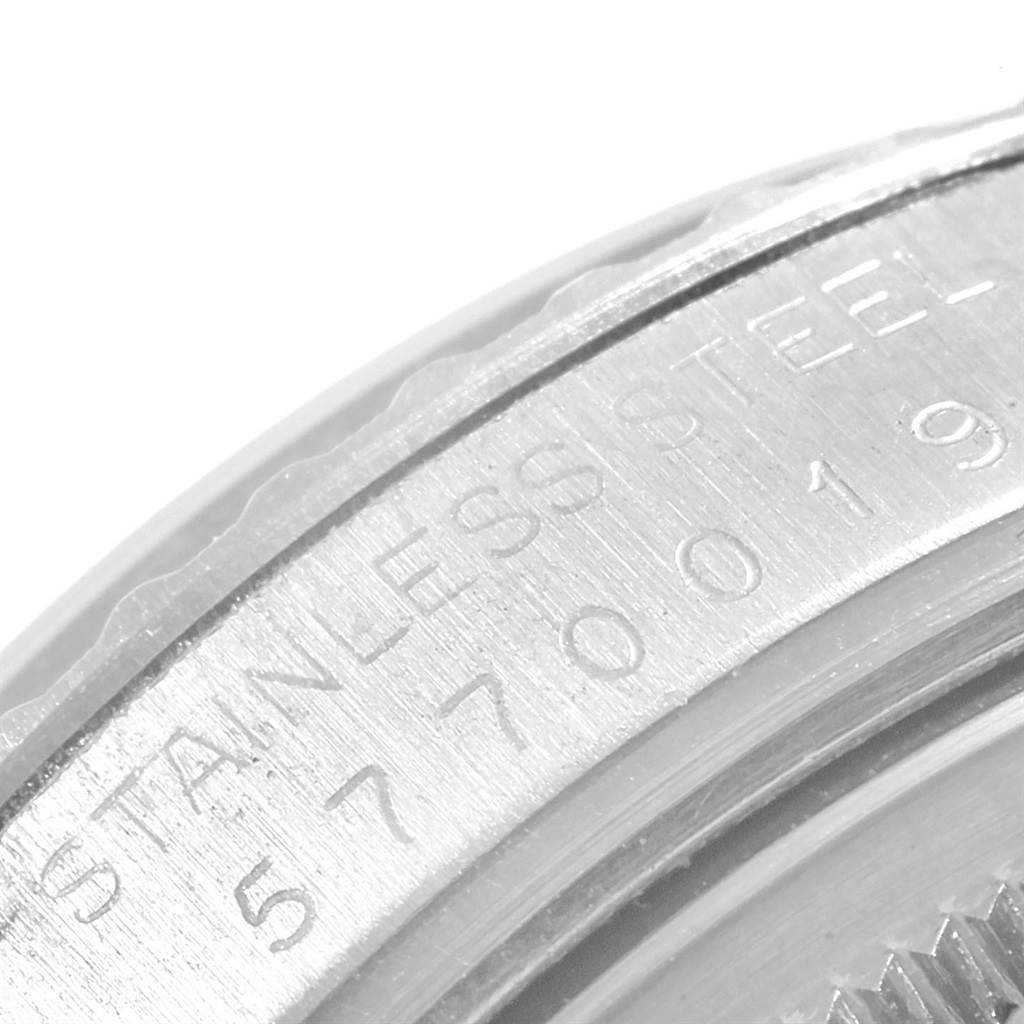 This image shows a close-up of the stainless steel case back edge of a Rolex Vintage Collection 16030 Men's Stainless Steel Silver Dial 16030 Men's Stainless Steel Silver Dial watch, including part of its serial number.