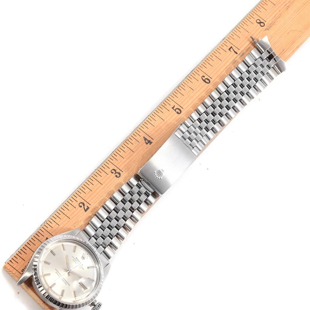 The Vintage Collection Rolex watch is shown parallel to a ruler, displaying its face and metal bracelet.