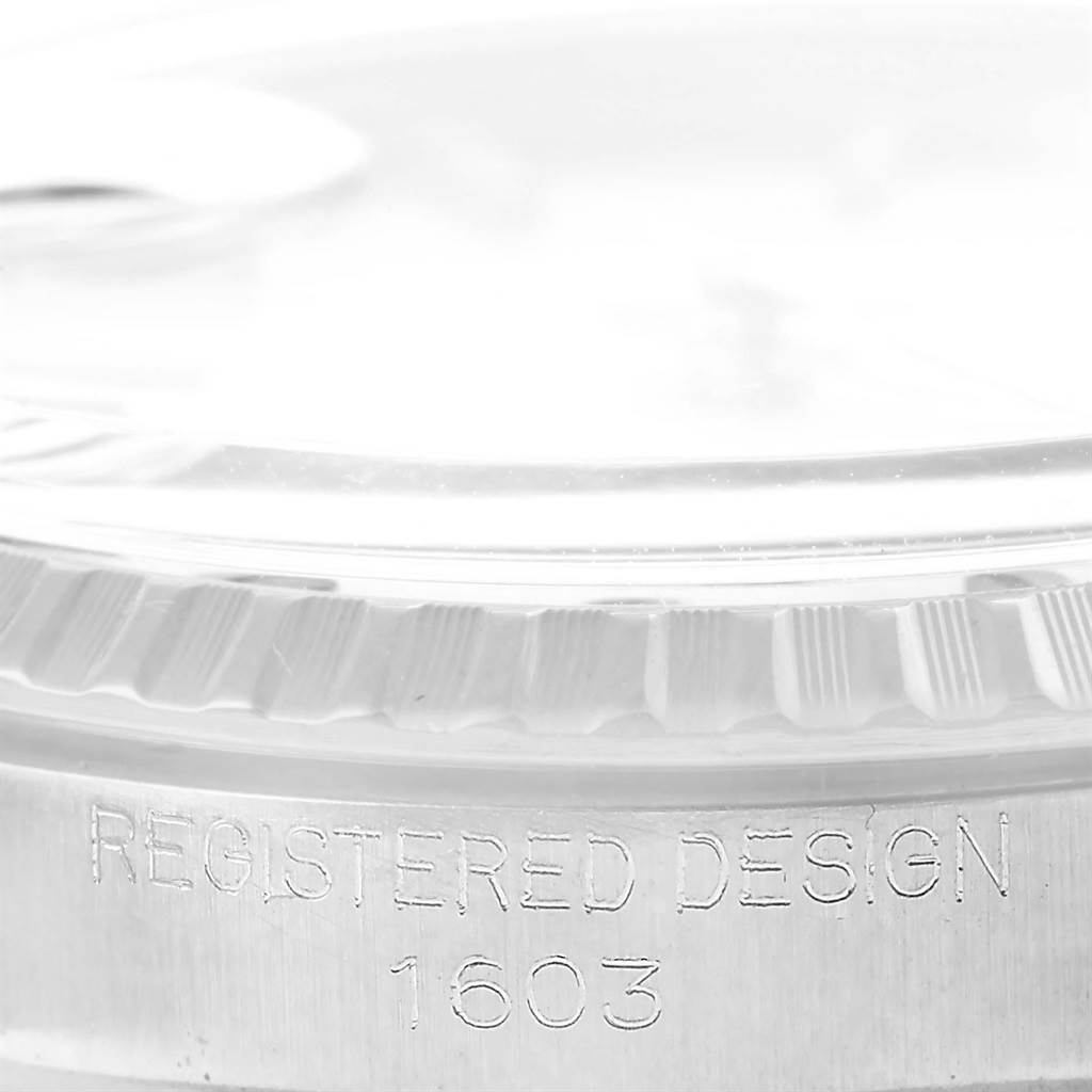 The image shows a close-up of the side casing and bezel of the Rolex Vintage Collection 1603 Men's Stainless Steel Silver Dial 1603 Men's Stainless Steel Silver Dial model 1603, inscribed with "REGISTERED DESIGN 1603."