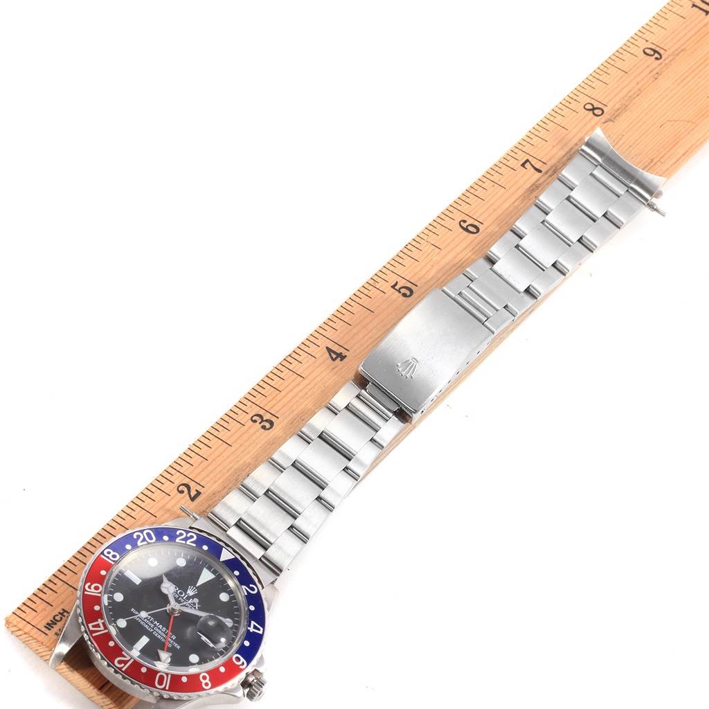 The image shows a Vintage Collection Rolex watch laid flat next to a ruler, displaying the face, bezel, and bracelet band.