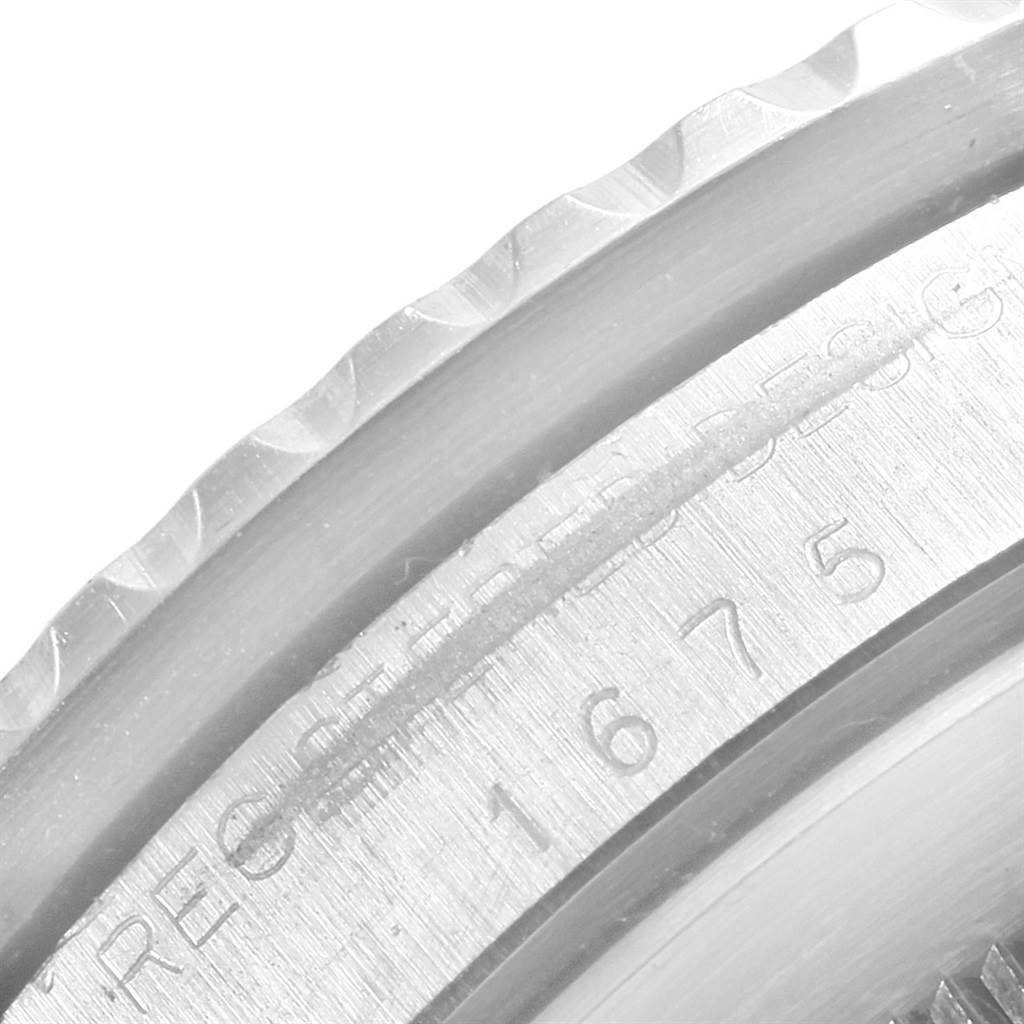 This close-up image shows a partial view of the bezel and serial number engraving on a Vintage Collection Rolex watch.