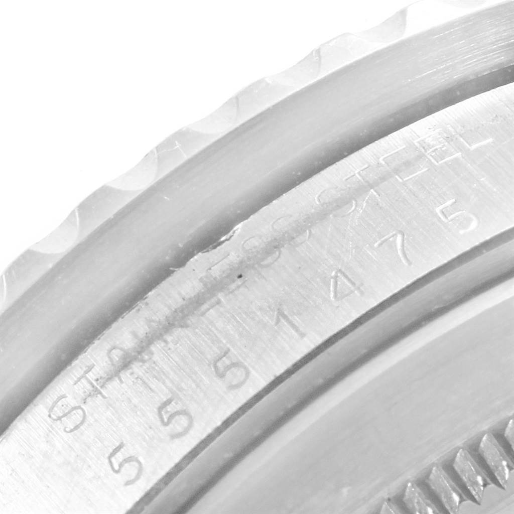 The image shows a close-up of the case back and bezel edge of a Vintage Collection model by Rolex.