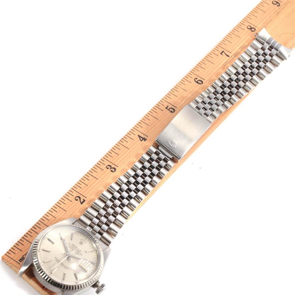 The Rolex Vintage Collection 16014 Men
s Stainless Steel Silver Dial 16014 Men
s Stainless Steel Silver Dial watch is shown at a top view angle, highlighting the watch face, bracelet, and clasp against a ruler.