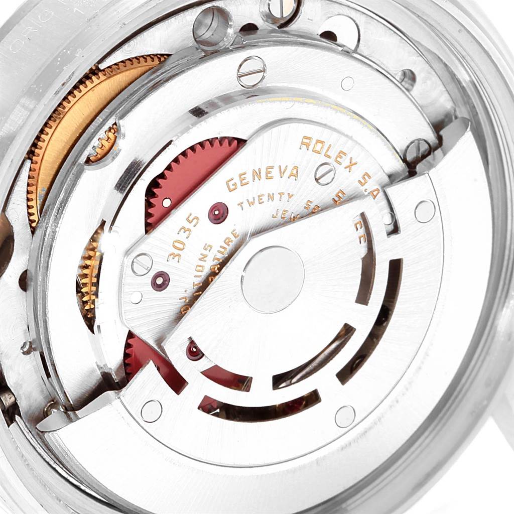 The image shows a close-up view of the mechanical movement inside a Vintage Collection Rolex, highlighting gears and the rotor.