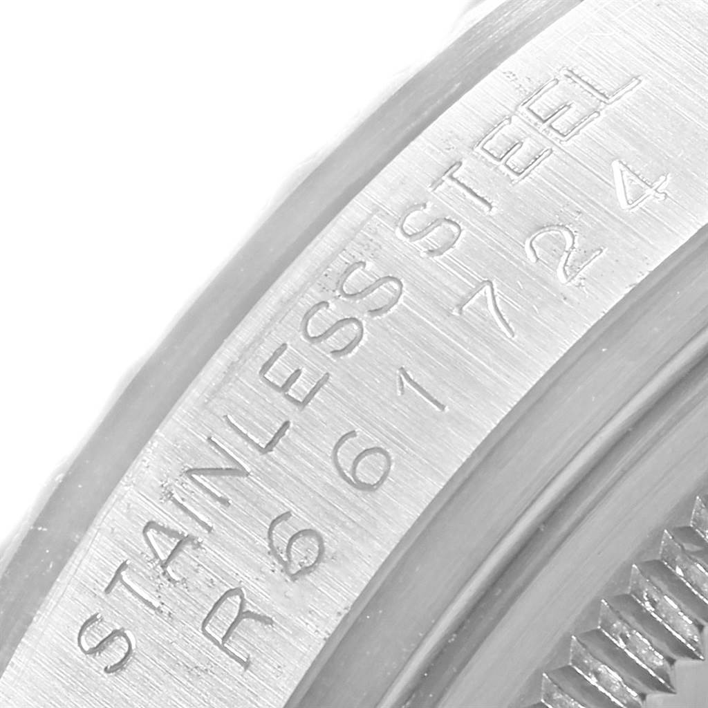 This image shows a close-up angle of the serial number and "STAINLESS STEEL" inscription on the edge of a Vintage Collection Rolex watch.