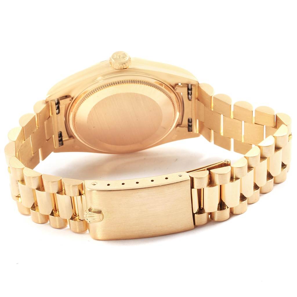 This image shows the back view of a Rolex Vintage Collection 1803 Men's Yellow Gold Silver Dial 1803 Men's Yellow Gold Silver Dial model, highlighting its case back, crown, and gold link bracelet with clasp.