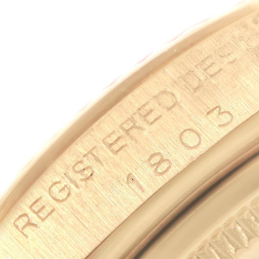 This close-up image shows the engraved edge of a Rolex Vintage Collection 1803 Men's Yellow Gold Silver Dial 1803 Men's Yellow Gold Silver Dial model watch.