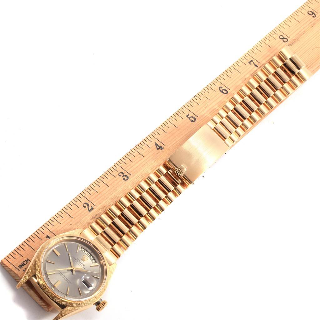 The image shows a Rolex Vintage Collection 1806 Men's Yellow Gold Grey Dial 1806 Men's Yellow Gold Grey Dial watch at an angle, featuring the watch face, band, and a measuring ruler.