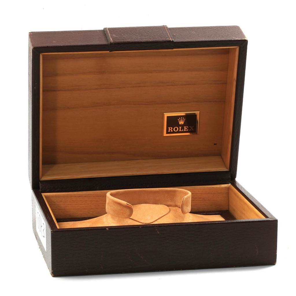 This image shows an open wooden box for the Vintage Collection model by Rolex, with a cushioned watch holder inside.