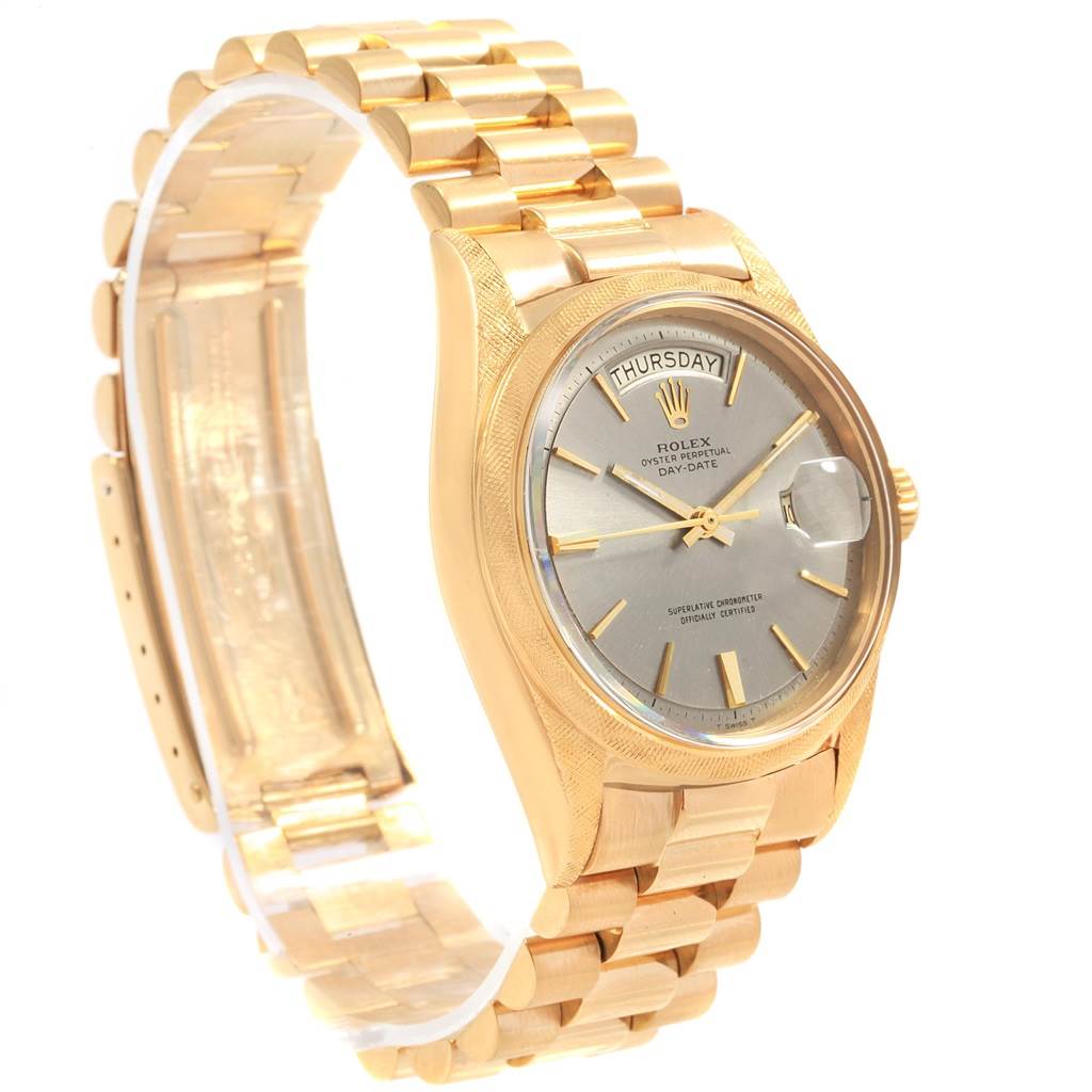 The Rolex Vintage Collection 1806 Men's Yellow Gold Grey Dial 1806 Men's Yellow Gold Grey Dial watch is shown at a three-quarters angle, highlighting its gold bracelet, case, and silver dial with day/date display.