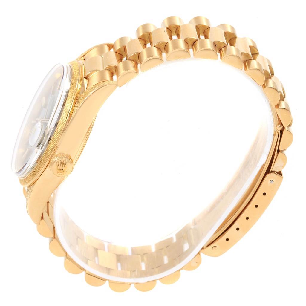 The Vintage Collection model by Rolex is shown from a side angle, highlighting the gold bracelet, crown, and part of the watch case.