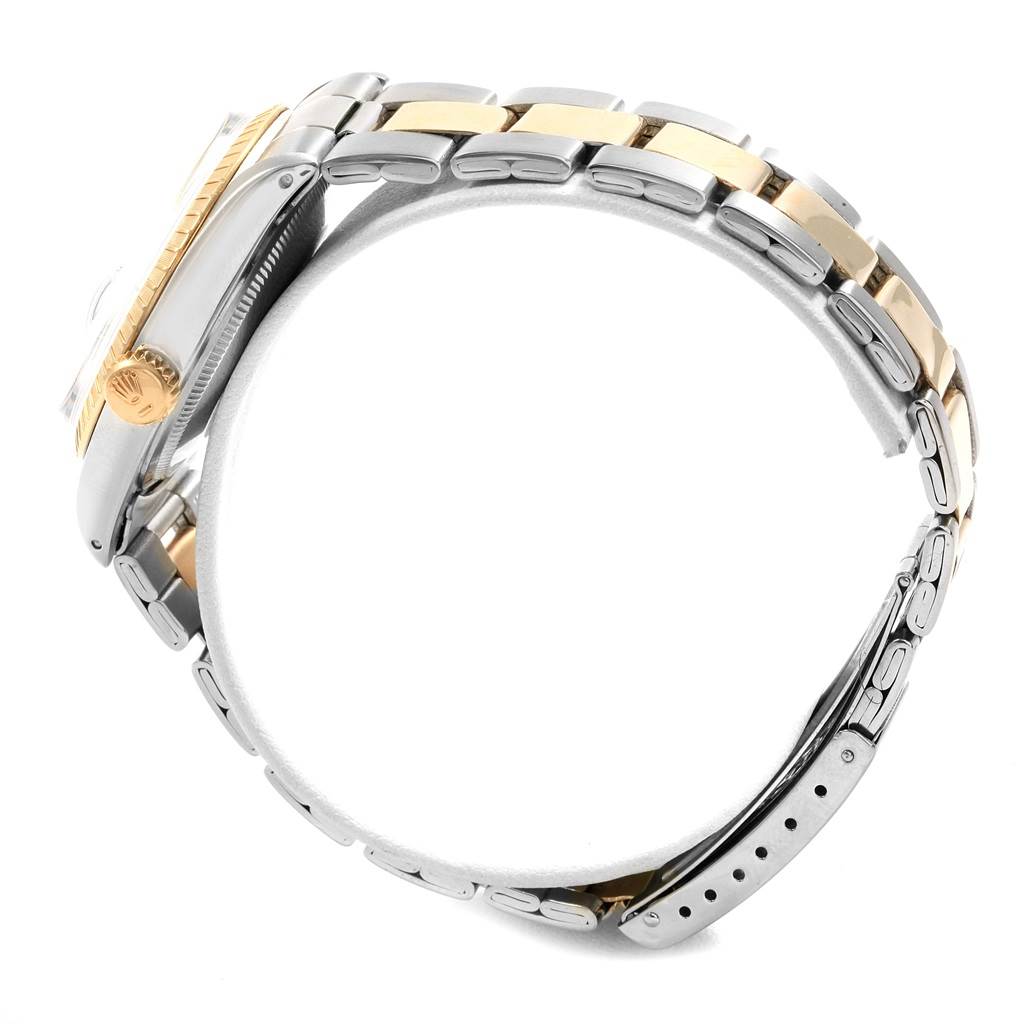 The image shows the side profile of the Rolex Vintage Collection 1505 Men's Steel and Gold (two tone) White Dial 1505 Men's Steel and Gold (two tone) White Dial watch, highlighting the crown and the gold and steel bracelet.