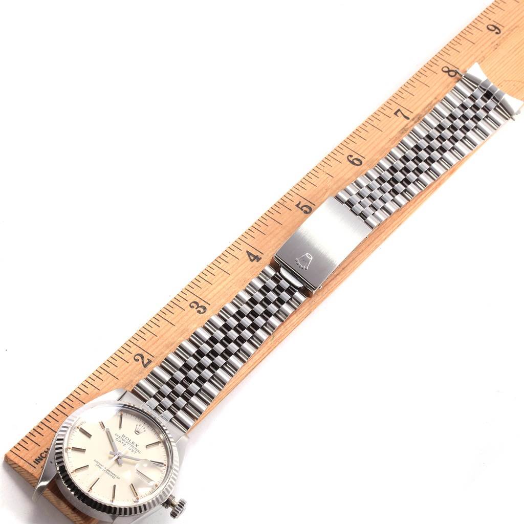 The Rolex Vintage Collection 16014 Men's Stainless Steel Silver Dial 16014 Men's Stainless Steel Silver Dial model watch is shown from the top, displaying the face, band, and clasp alongside a measuring ruler.