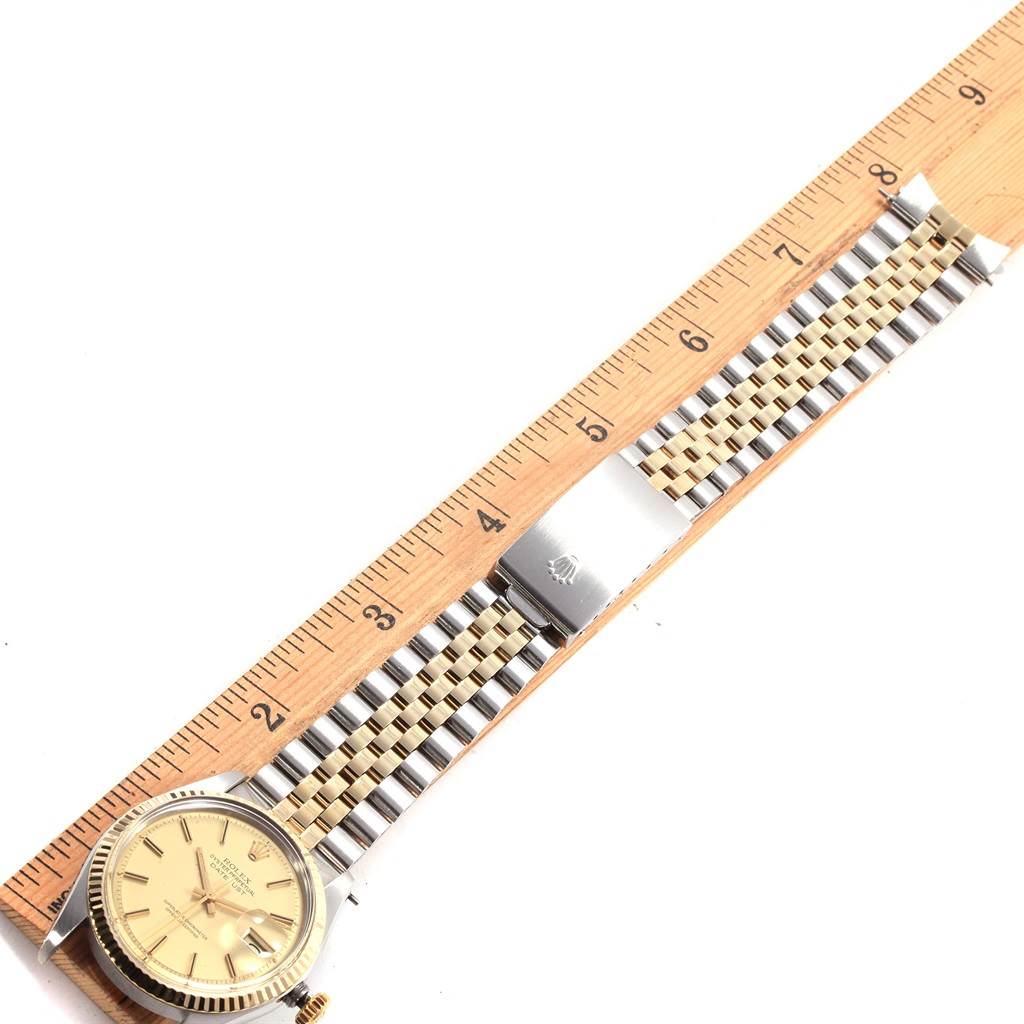 The Vintage Collection Rolex watch is shown from the top-down angle, displaying the full bracelet and face along with a ruler for scale.