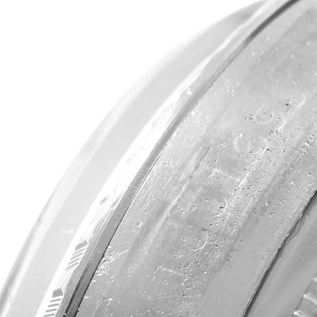 This close-up image shows the side of the bezel of a Rolex Vintage Collection 1601 Men's Stainless Steel Silver Dial 1601 Men's Stainless Steel Silver Dial watch.