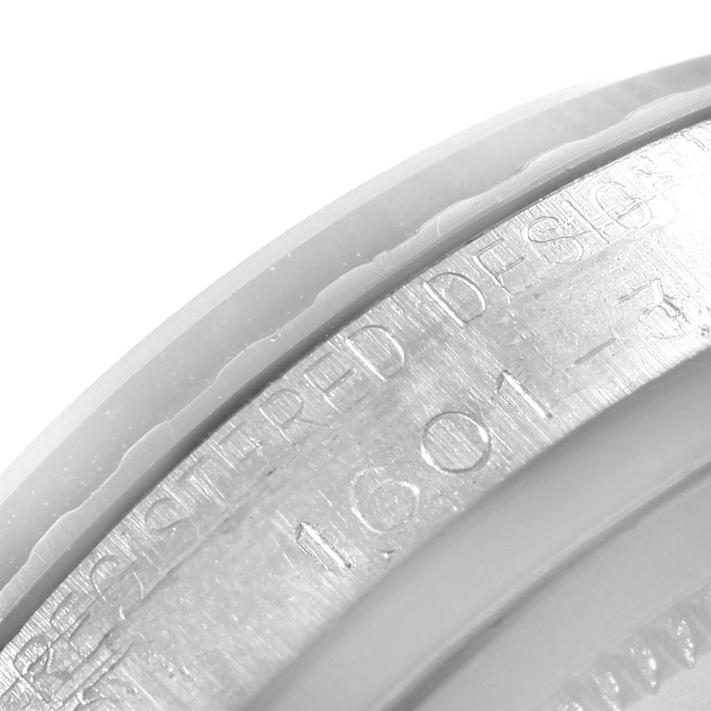 This image shows a close-up angle of the engraved serial number on the case of a Vintage Collection Rolex watch.