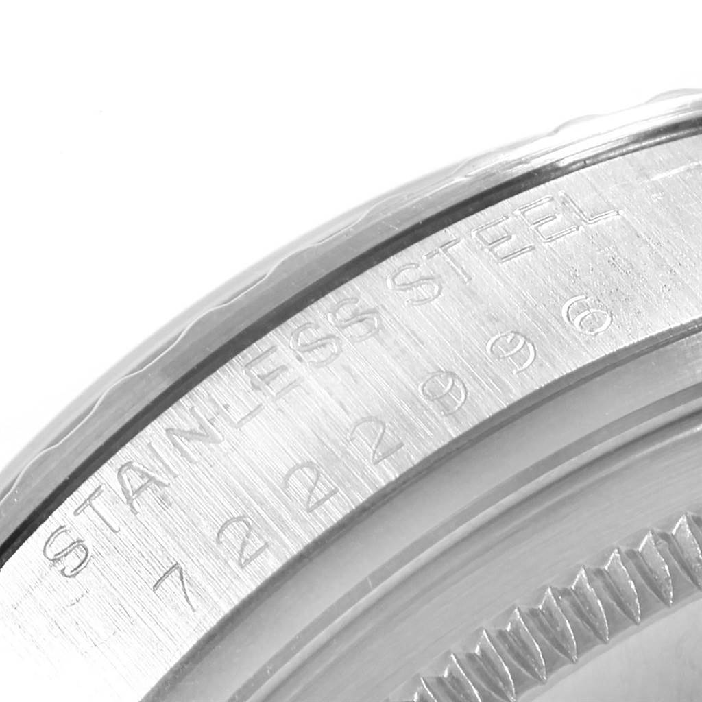 The image shows a close-up of the engraved details on the bezel and casing back of a Vintage Collection model by Rolex.