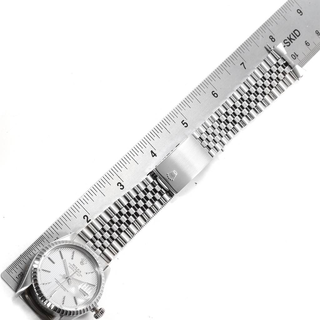 A Rolex Vintage Collection 16030 Men's Stainless Steel Silver Dial 16030 Men's Stainless Steel Silver Dial watch is shown next to a ruler, displaying its face and metal strap.