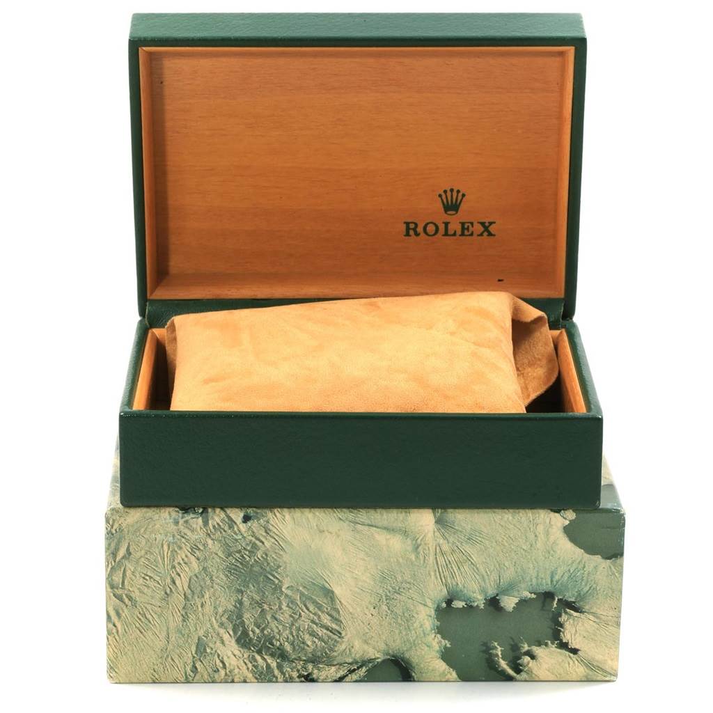 The image shows the open box of a Vintage Collection Rolex watch, featuring the brand's logo inside the lid with the watch covered by a suede cloth.