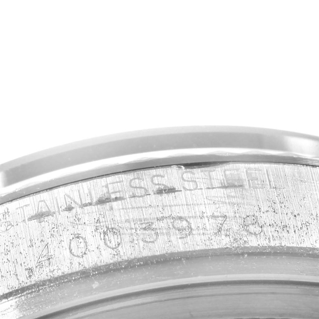 The image shows a close-up of the stainless steel case with engraved serial numbers of a Rolex Vintage Collection 1601 Men's Stainless Steel Silver Dial 1601 Men's Stainless Steel Silver Dial watch.