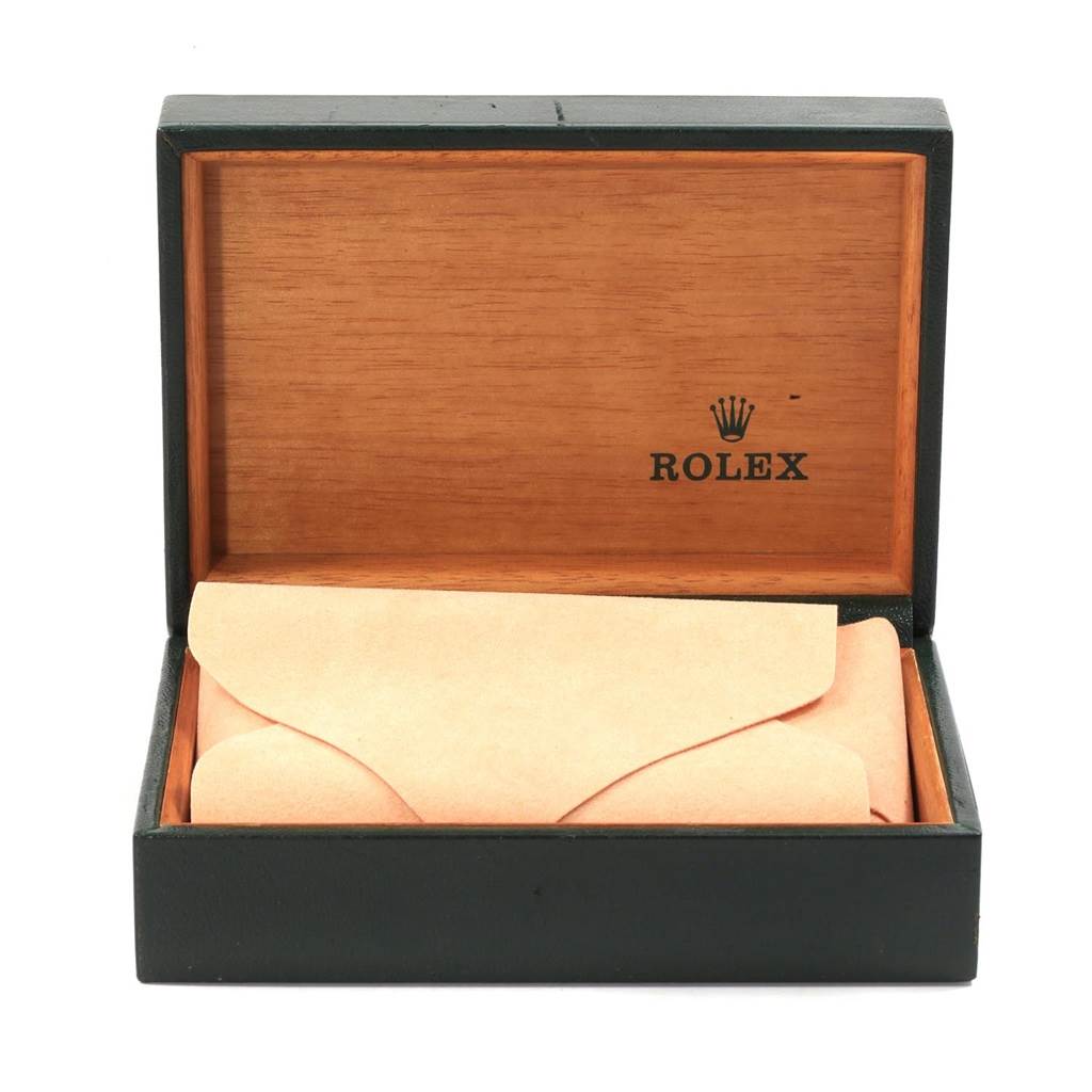 This image shows an open Rolex Vintage Collection 1601 Men's Stainless Steel Silver Dial 1601 Men's Stainless Steel Silver Dial watch box made of wood, with the watch encased in a beige protective wrap inside.