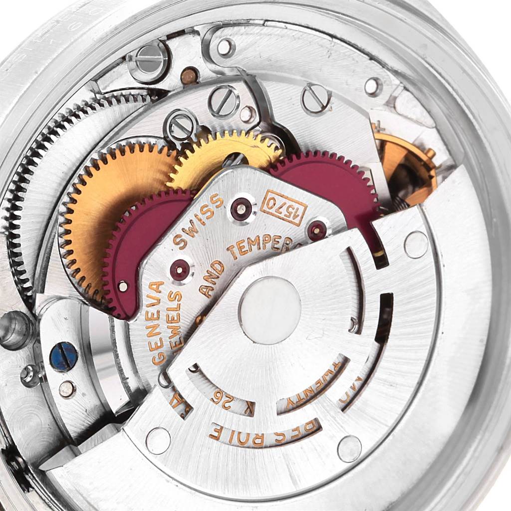 The image shows a close-up of the inner mechanical parts of a Vintage Collection Rolex watch.