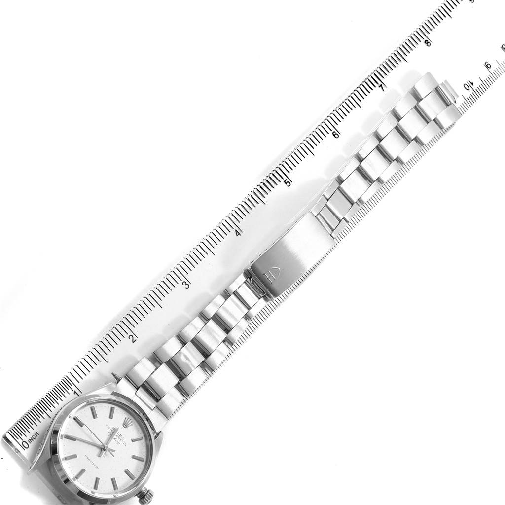 This image displays a flat-lay view of the Rolex Vintage Collection 5500 Men's Stainless Steel Silver Dial 5500 Men's Stainless Steel Silver Dial watch, showing the face, band, and clasp against a ruler.