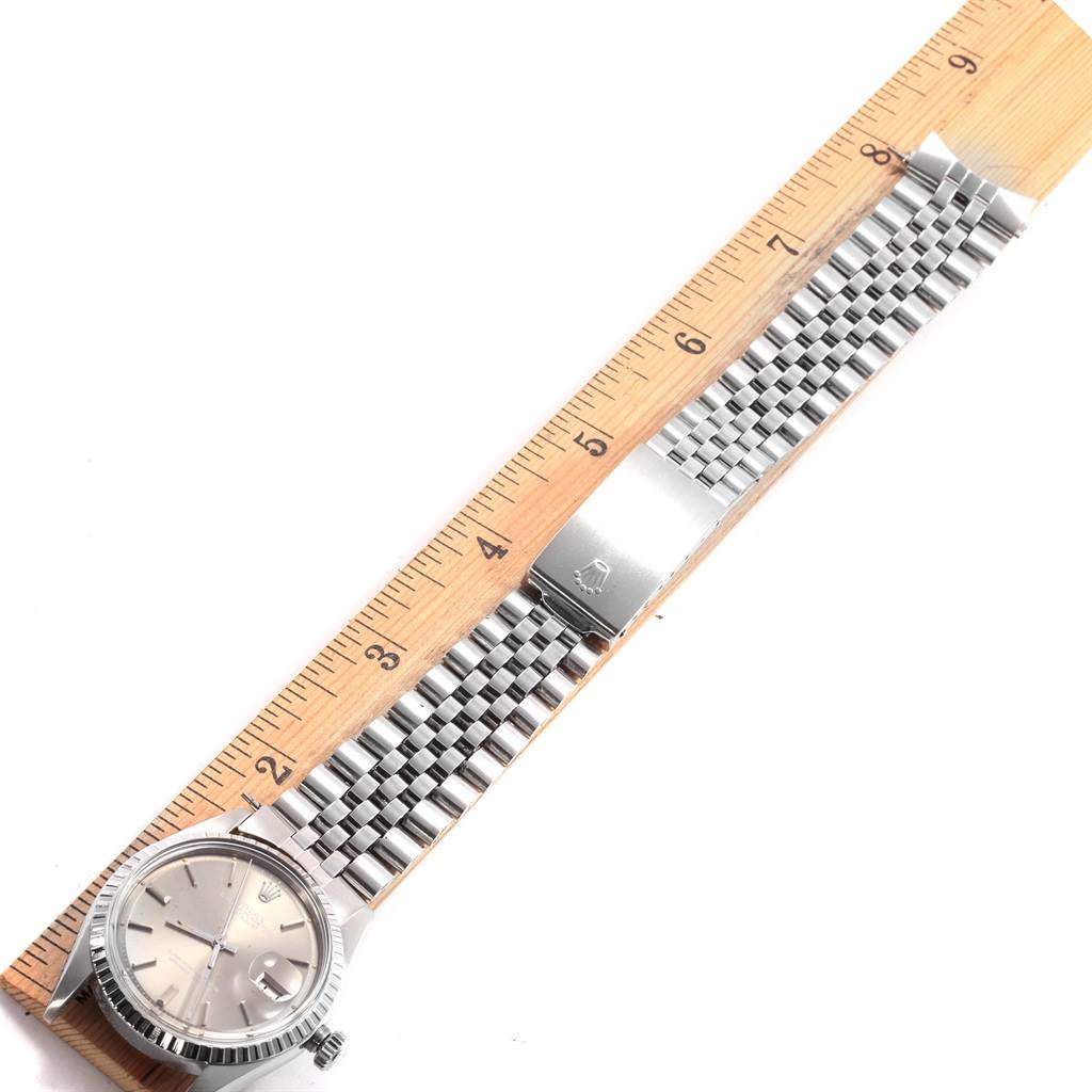 The Rolex Vintage Collection 1603 Men's Stainless Steel Grey Dial 1603 Men's Stainless Steel Grey Dial watch is displayed flat with its band extended alongside a ruler showing its length.