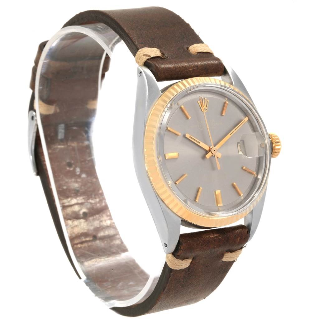 This is a Rolex Vintage Collection 1601 Men's Steel and Gold (two tone) Grey Dial 1601 Men's Steel and Gold (two tone) Grey Dial model shown at a three-quarter angle, featuring a brown leather strap and a gold bezel.