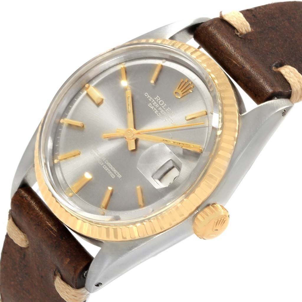 This is a close-up angled view of a Rolex Vintage Collection 1601 Men's Steel and Gold (two tone) Grey Dial 1601 Men's Steel and Gold (two tone) Grey Dial watch, showing the dial, bezel, crown, and part of the leather strap.